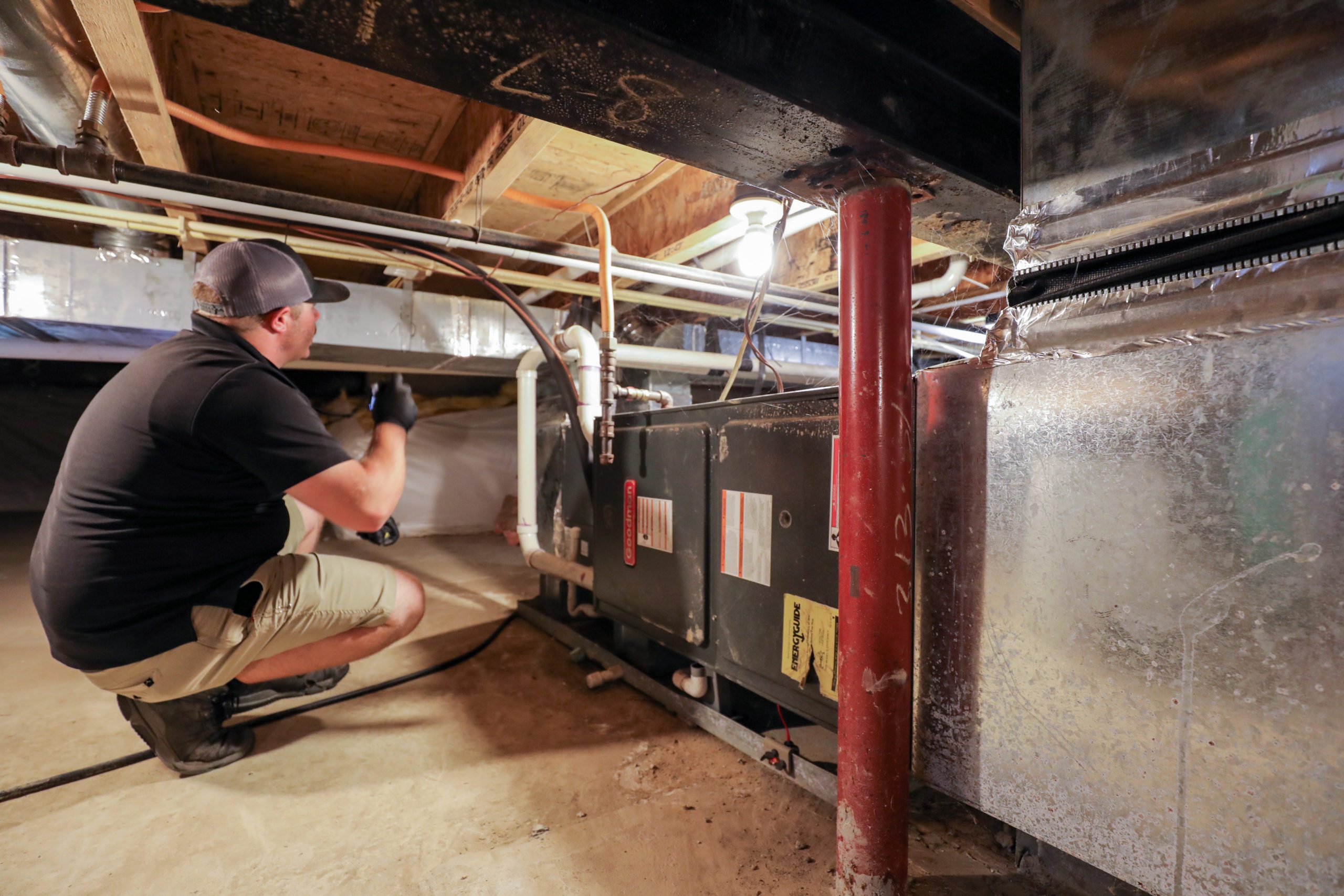 High Tech Inspections employee in crawl space