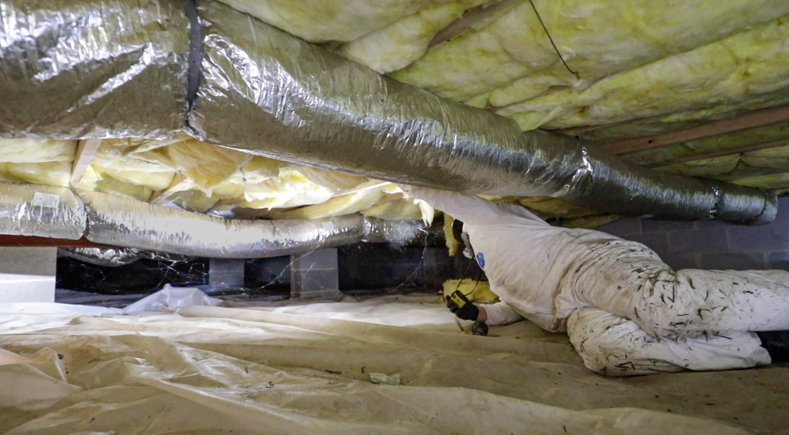 High Tech Inspection employee in a crawl space