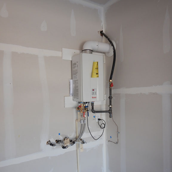 white control panel attached to the wall by High Tech Inspections