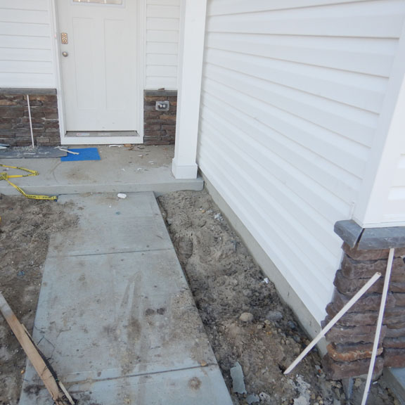 Concrete walkway towards front door under inspection