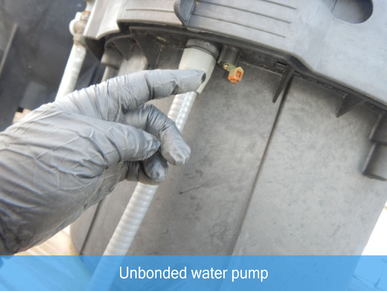 High Tech Inspections employee pointing to unbonded water pump
