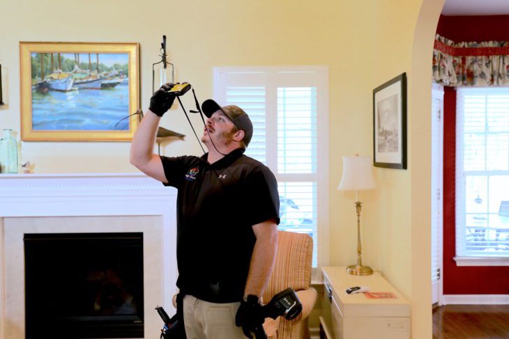 High Tech home inspector taking pictures inside a house