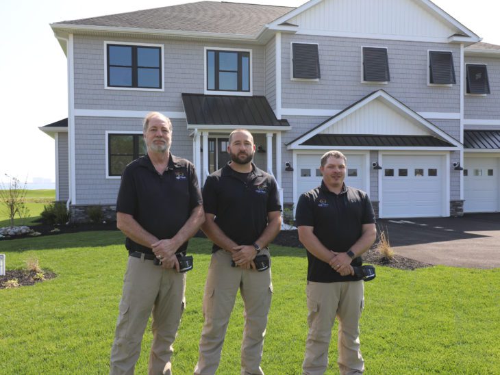 three High Tech home inspectors standing outside a house