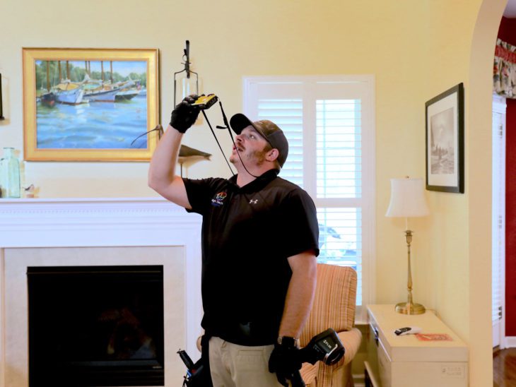 High Tech home inspector taking pictures inside a house